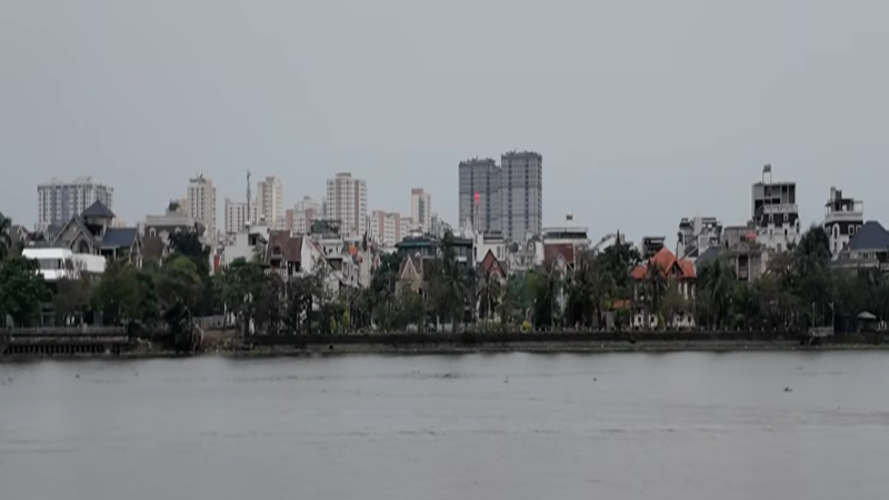 Futuristic skyline of Ho Chi Minh City's Thu Thiem and Saigon River at night with illuminated digital blockchain nodes overlaying prime residential towers.
