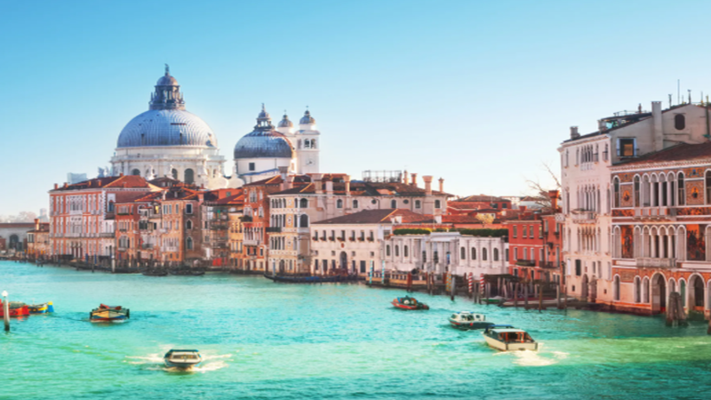 A historic Venetian Palazzo on the Grand Canal at twilight, overlaid with digital blockchain nodes and Euro-stablecoin yield charts representing institutional RWA investment.