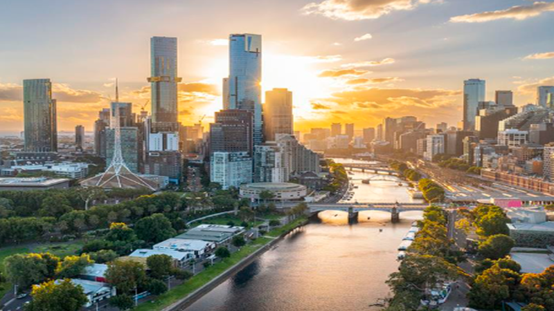 Panoramic twilight view of Melbourne's CBD skyline and Yarra River, overlaid with digital blockchain security token network graphics indicating institutional real estate investment.